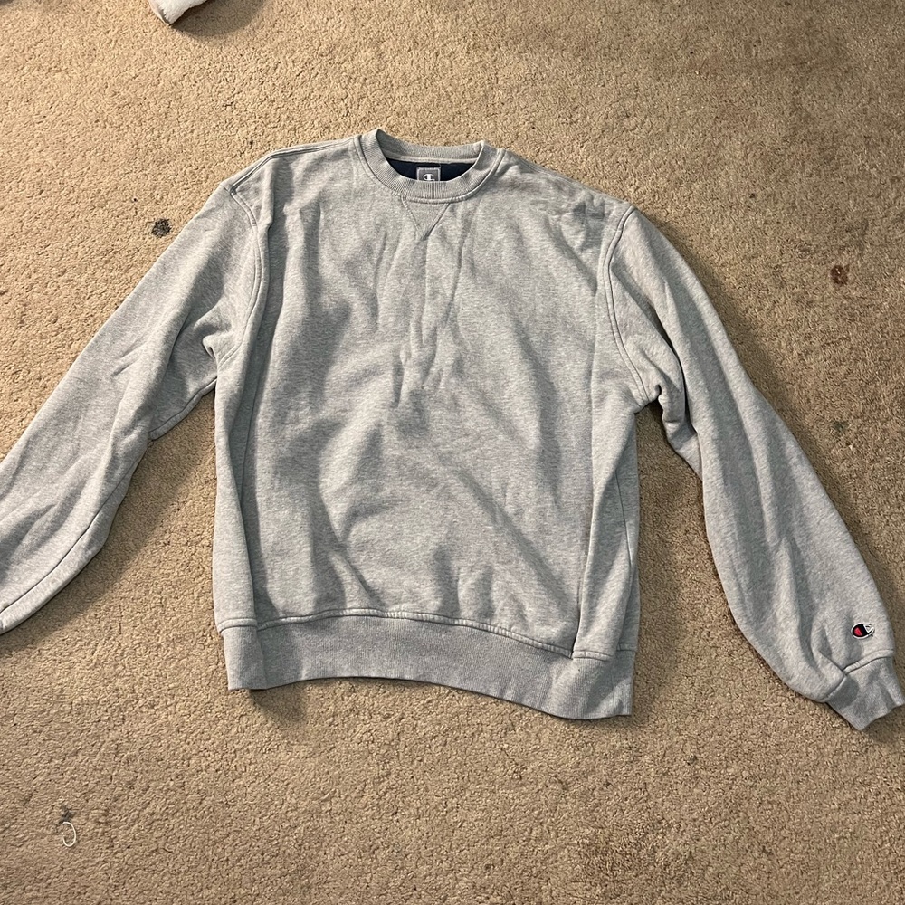 Used champion sweater with a small spot on the sleeve